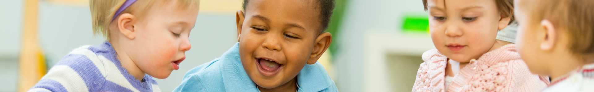 Happy toddlers playing with each other.